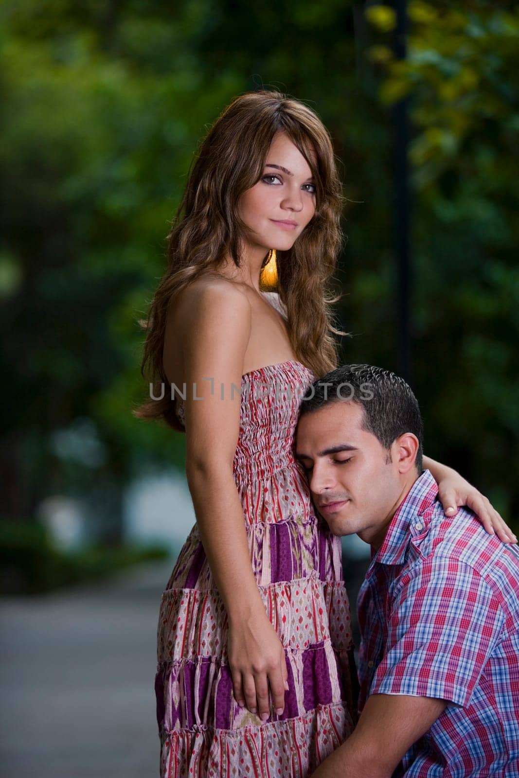 Side profile of a young couple romancing in a park