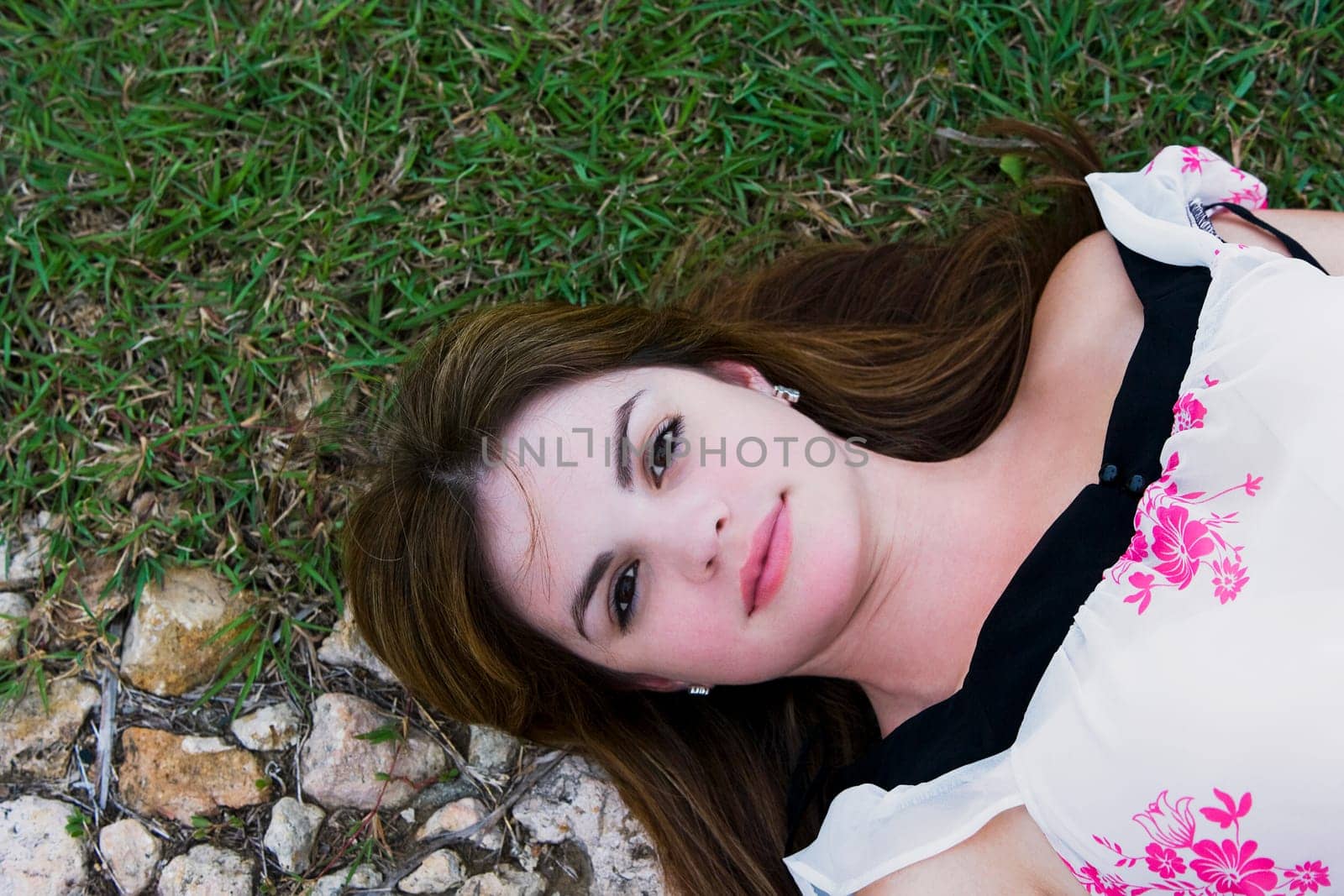 High angle view of a young woman lying on grass