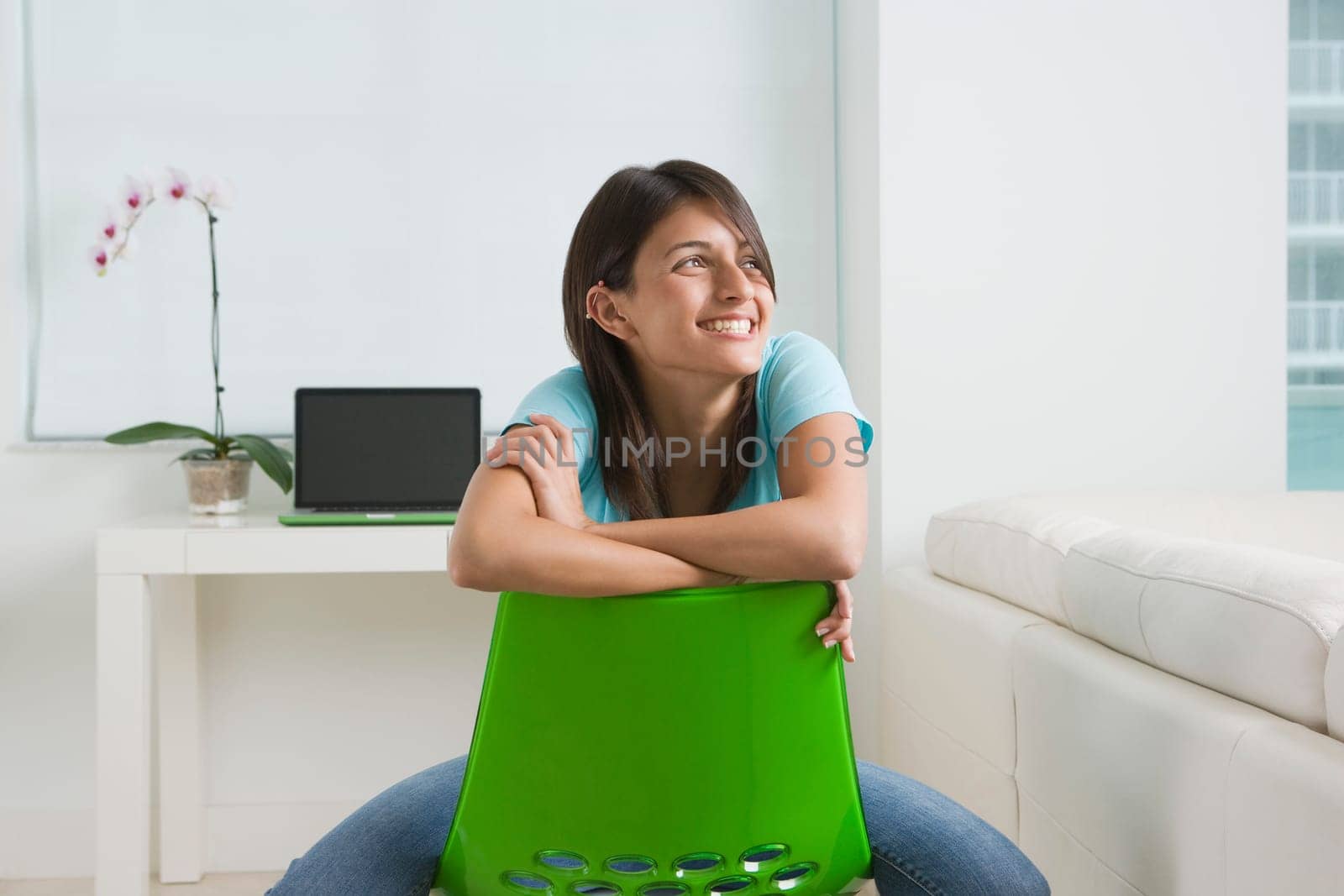 Teenage girl sitting on a chair and smiling