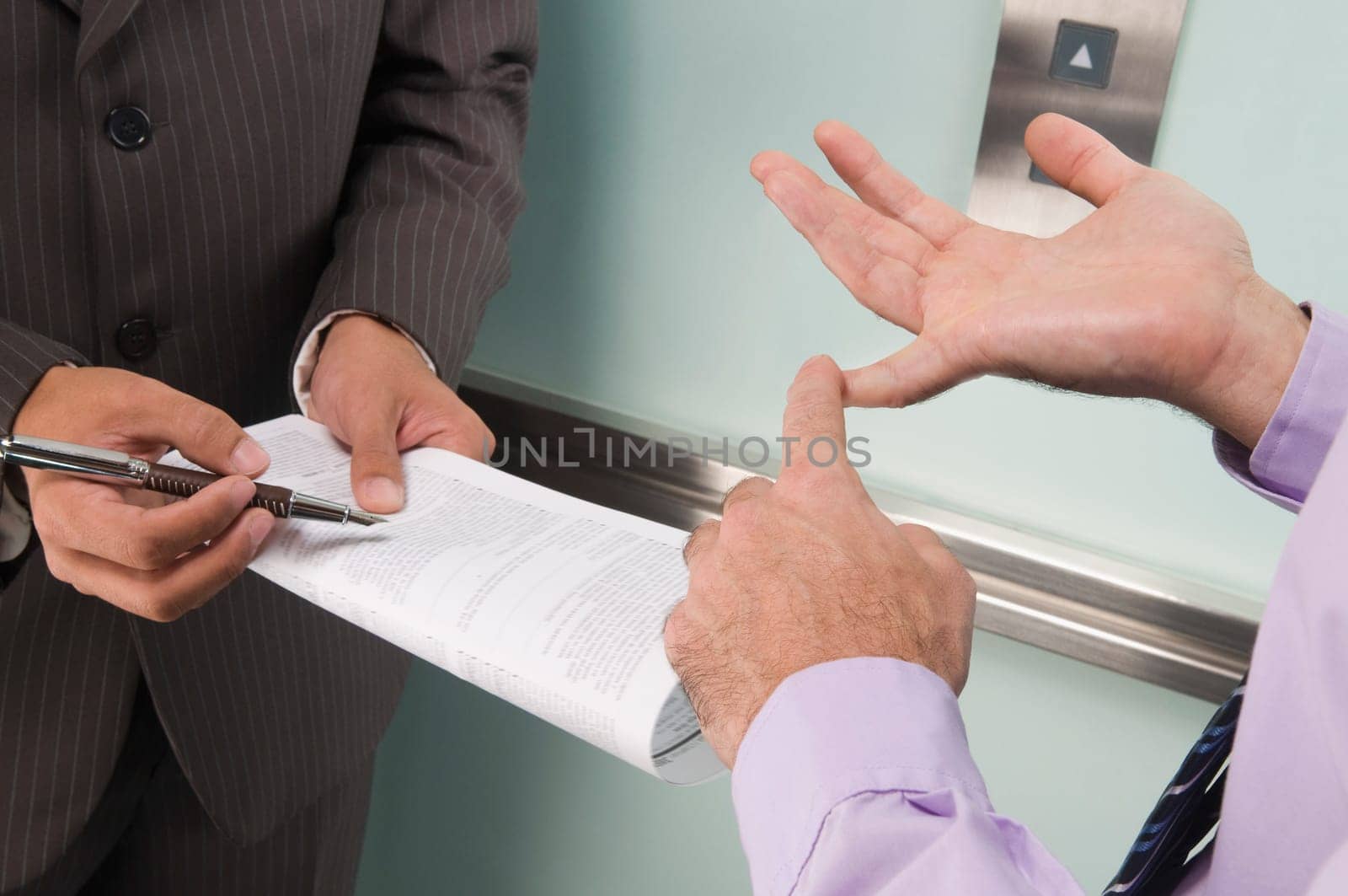 Businessmen discussing in an elevator