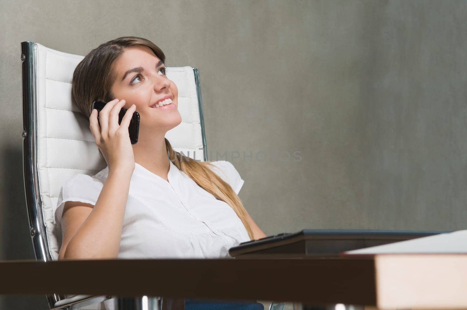 Businesswoman talking on a mobile phone in an office