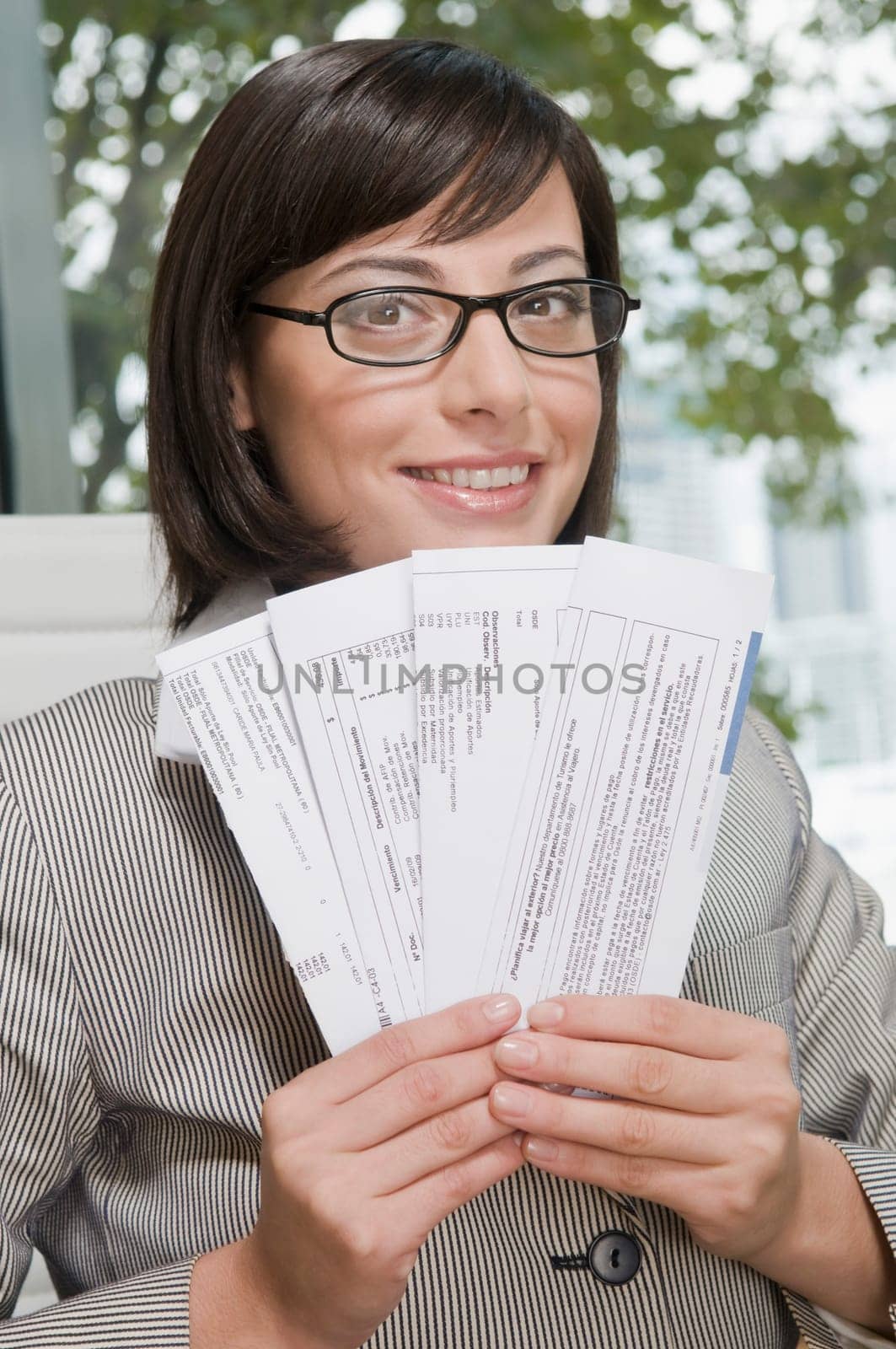Portrait of a businesswoman holding bills and smiling