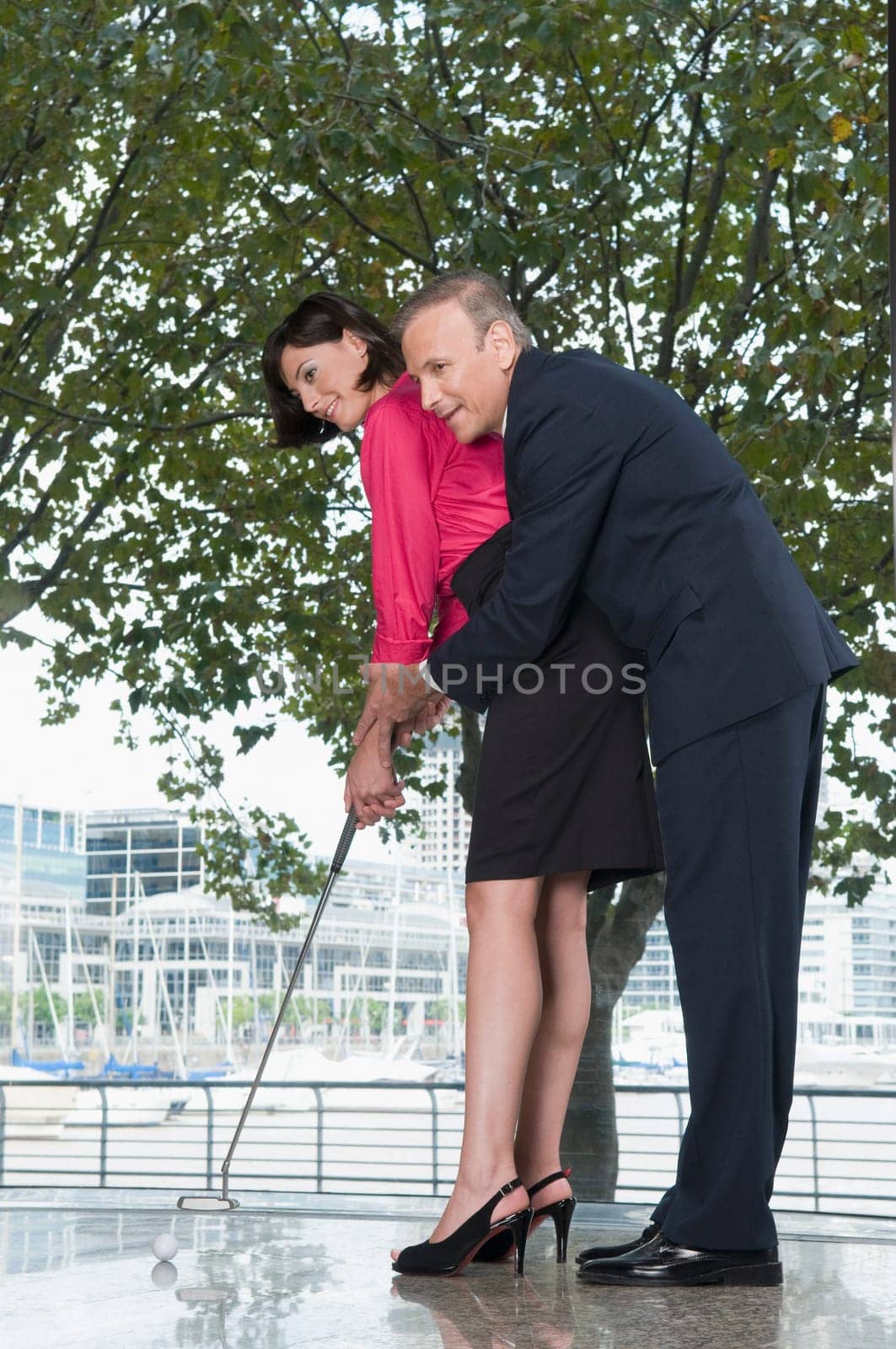 business executives playing golf in an office