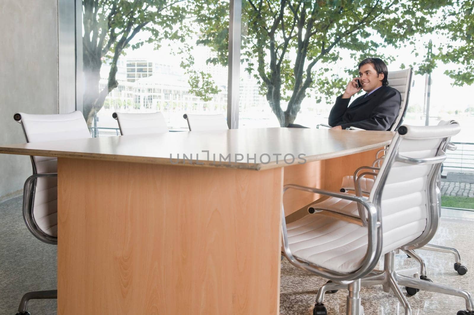 Businessman talking on a mobile phone in a conference room
