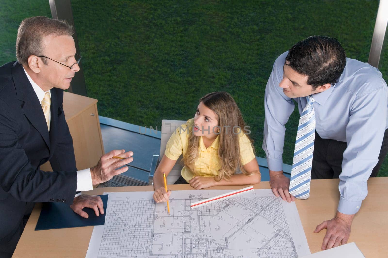 Architects discussing a blueprint in an office