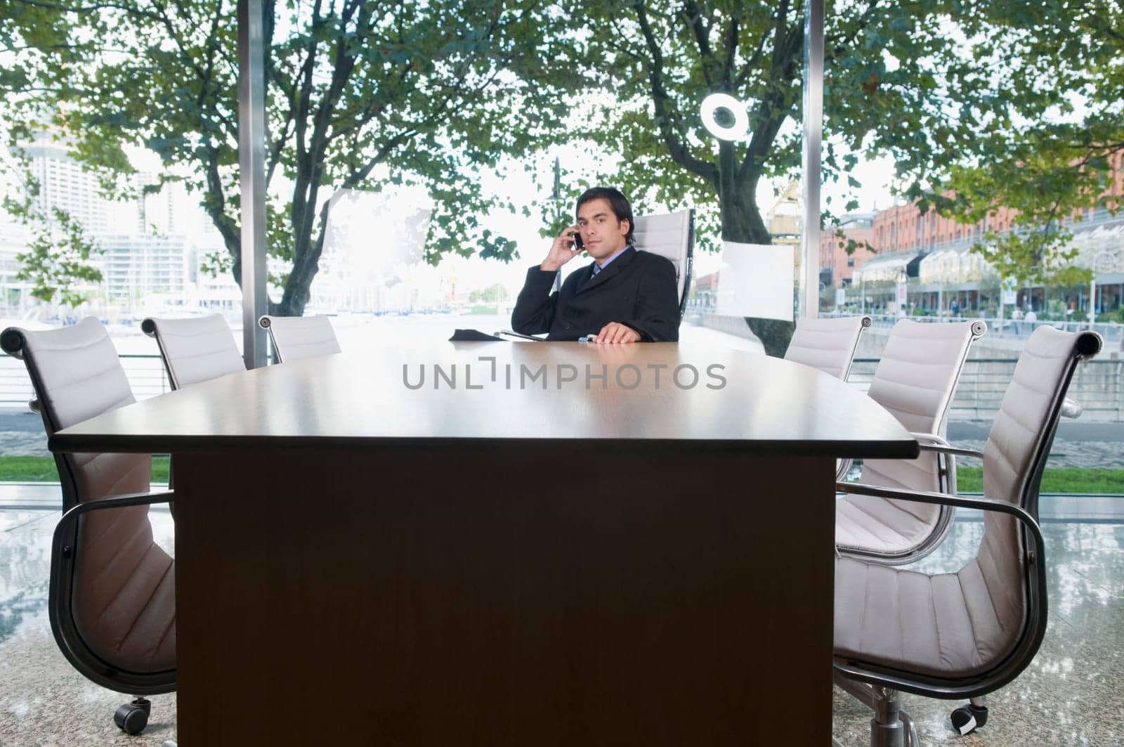 Businessman talking on a mobile phone in a conference room