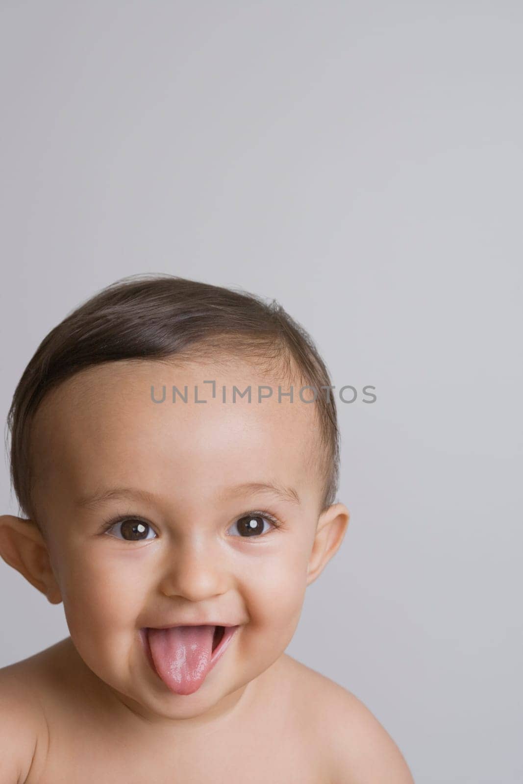 Close-up of a baby boy sticking his tongue out