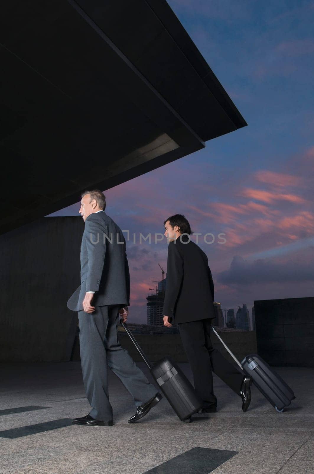 Businessmen carrying luggage