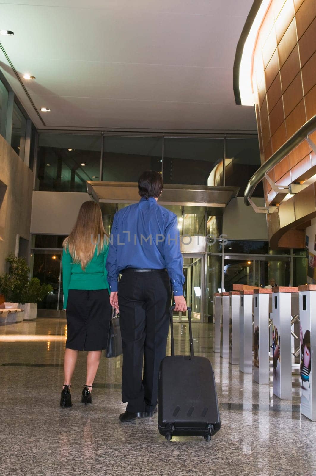 Businesswoman and a businessman walking at an airport