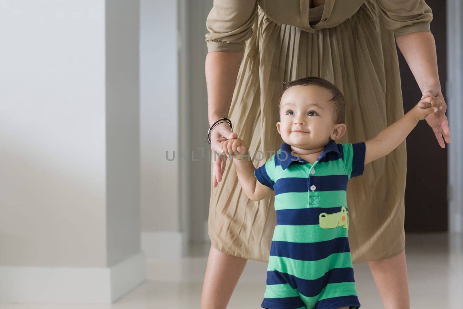 Mother helping her son in walking