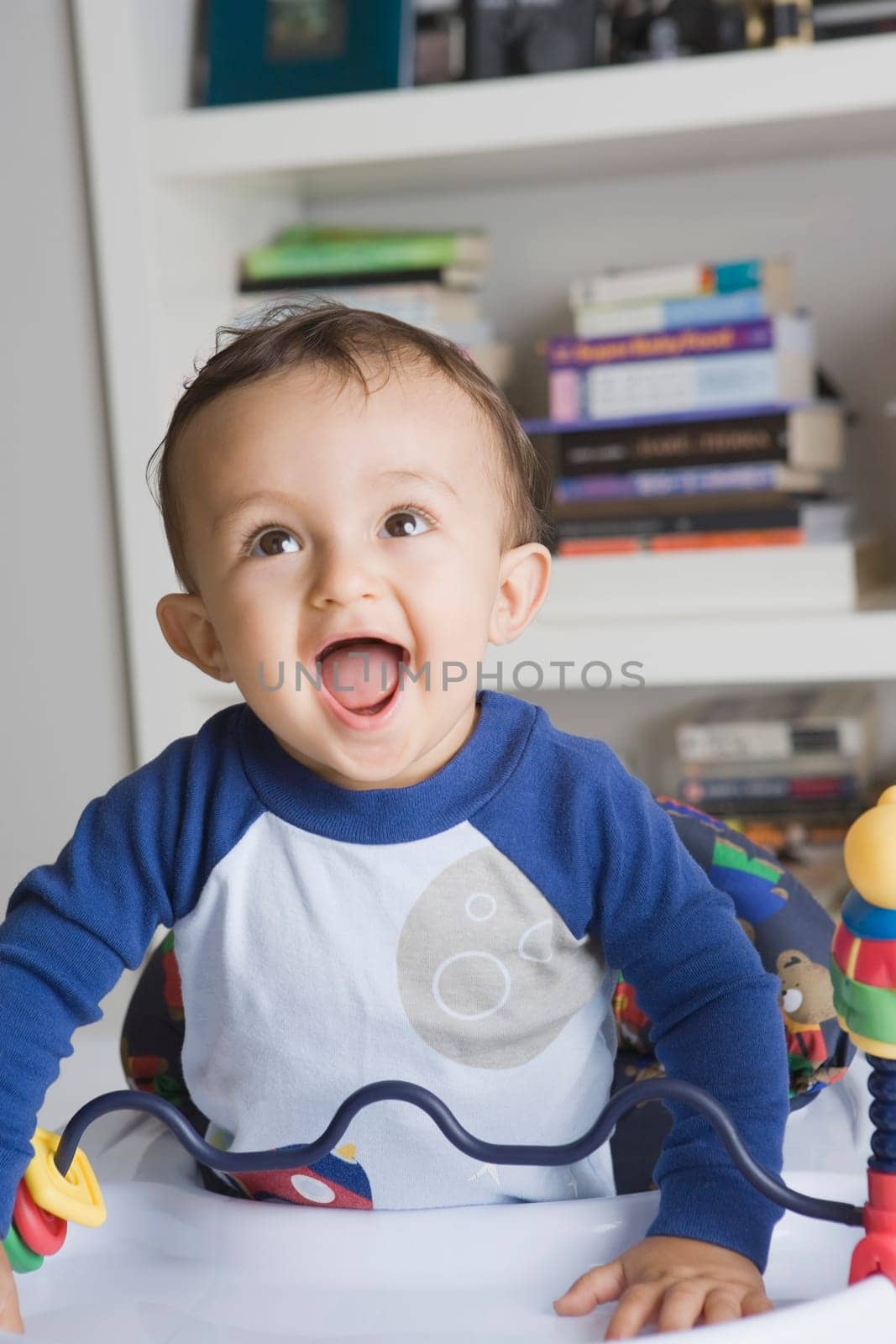 Baby boy playing in a walker