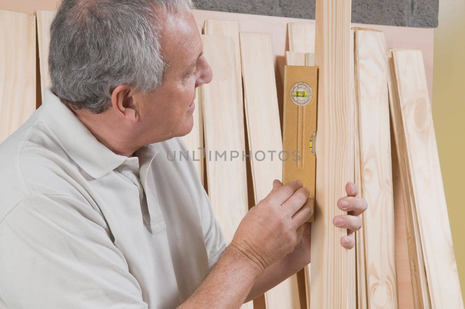 Man checking the level of a wooden plank