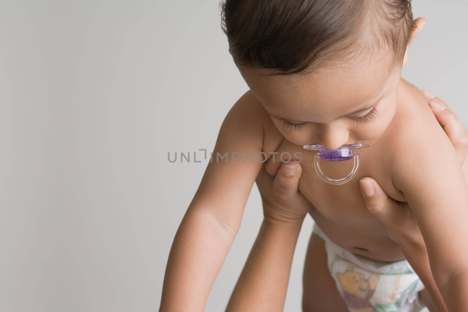 Baby boy sucking a pacifier