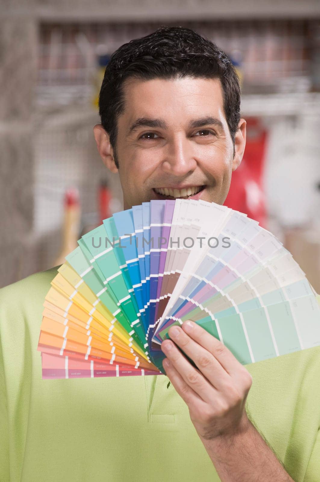 Man holding a color swatch in a hardware store
