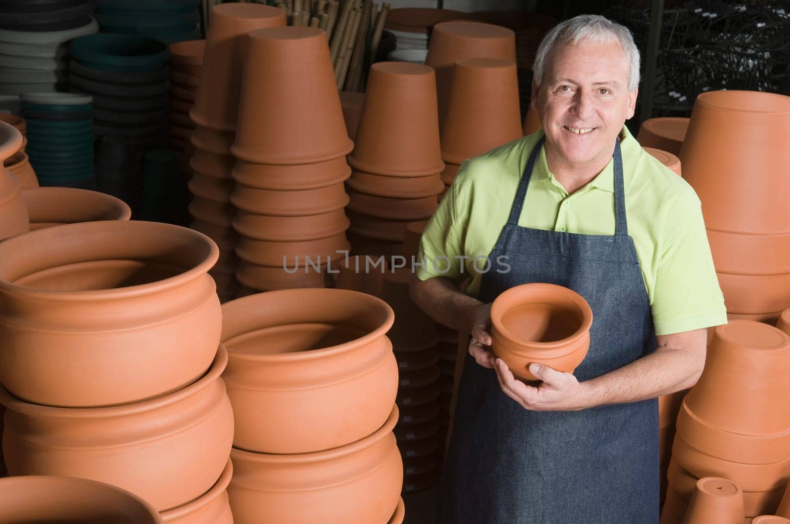 Man showing flower pot in a garden center