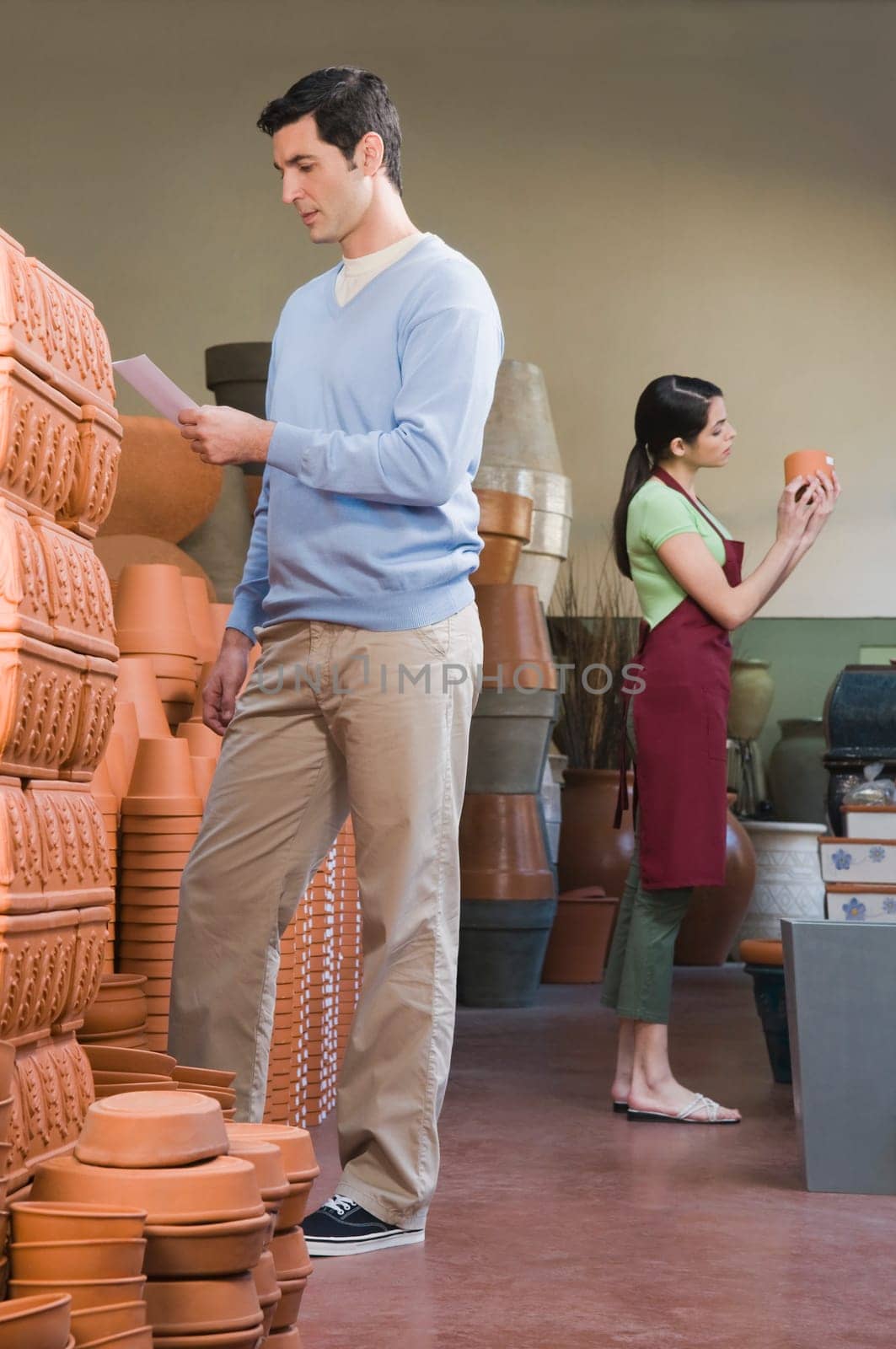 Man reading a shopping list in a garden center
