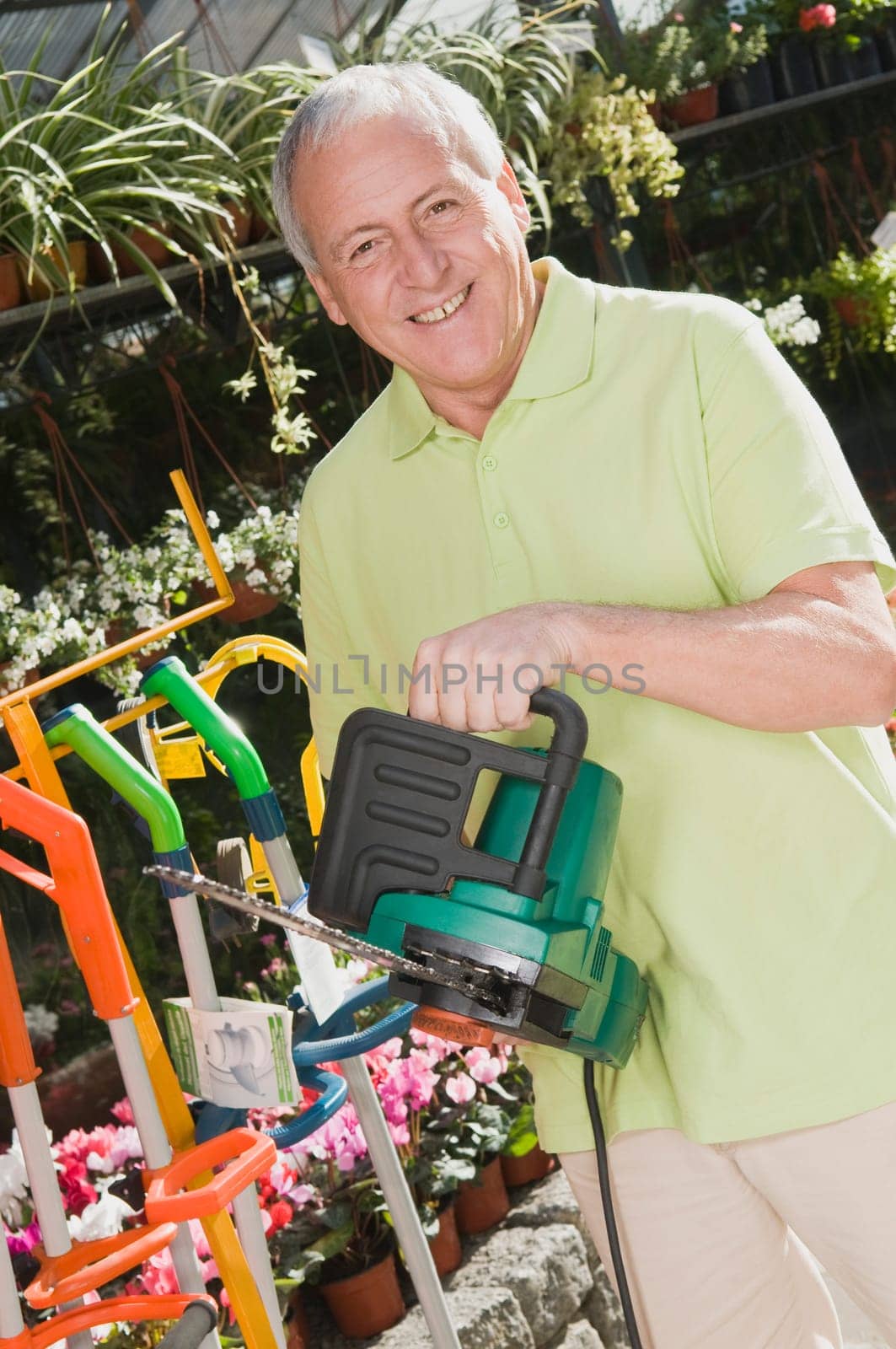 Man holding a chainsaw in a hardware store