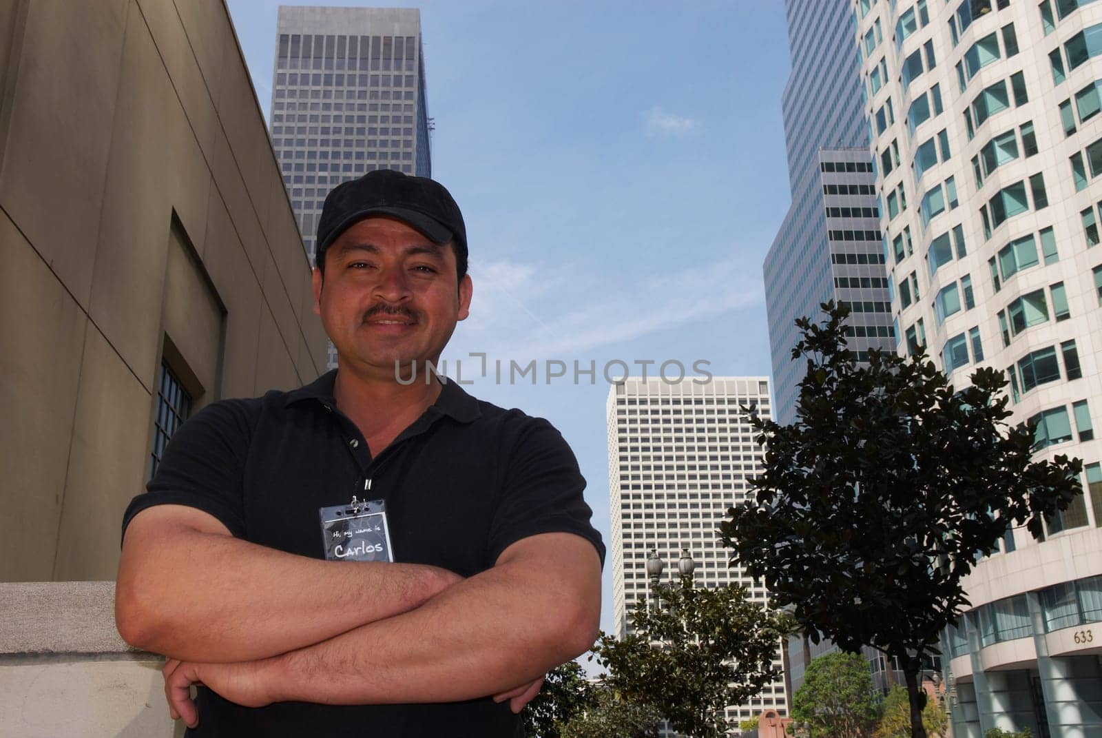Low angle view of a courier with his arms crossed