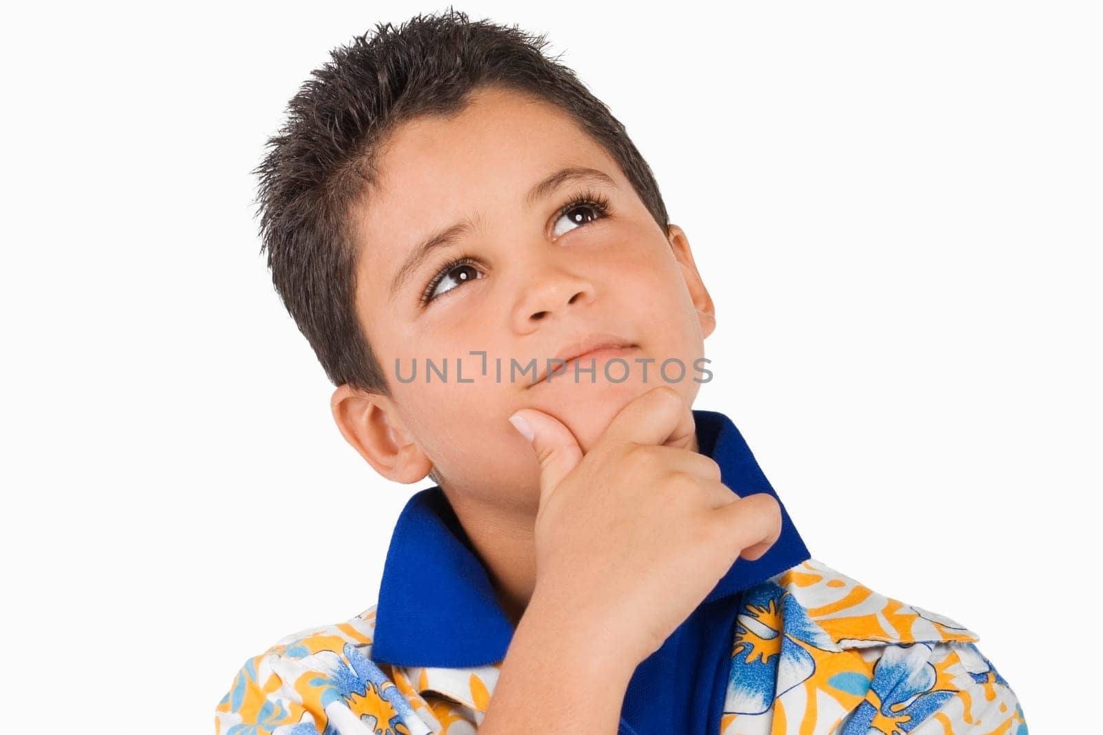 Close-up of a boy thinking with his hand on his chin