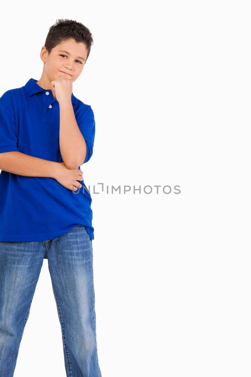 Portrait of a boy standing with his hand on his chin