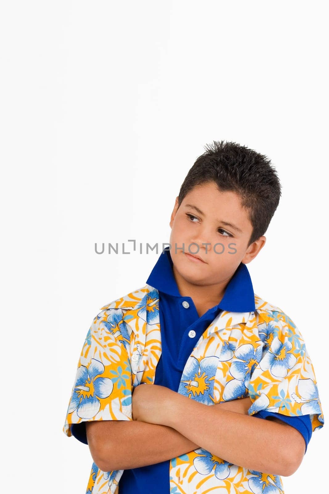 Close-up of a boy standing with his arms crossed