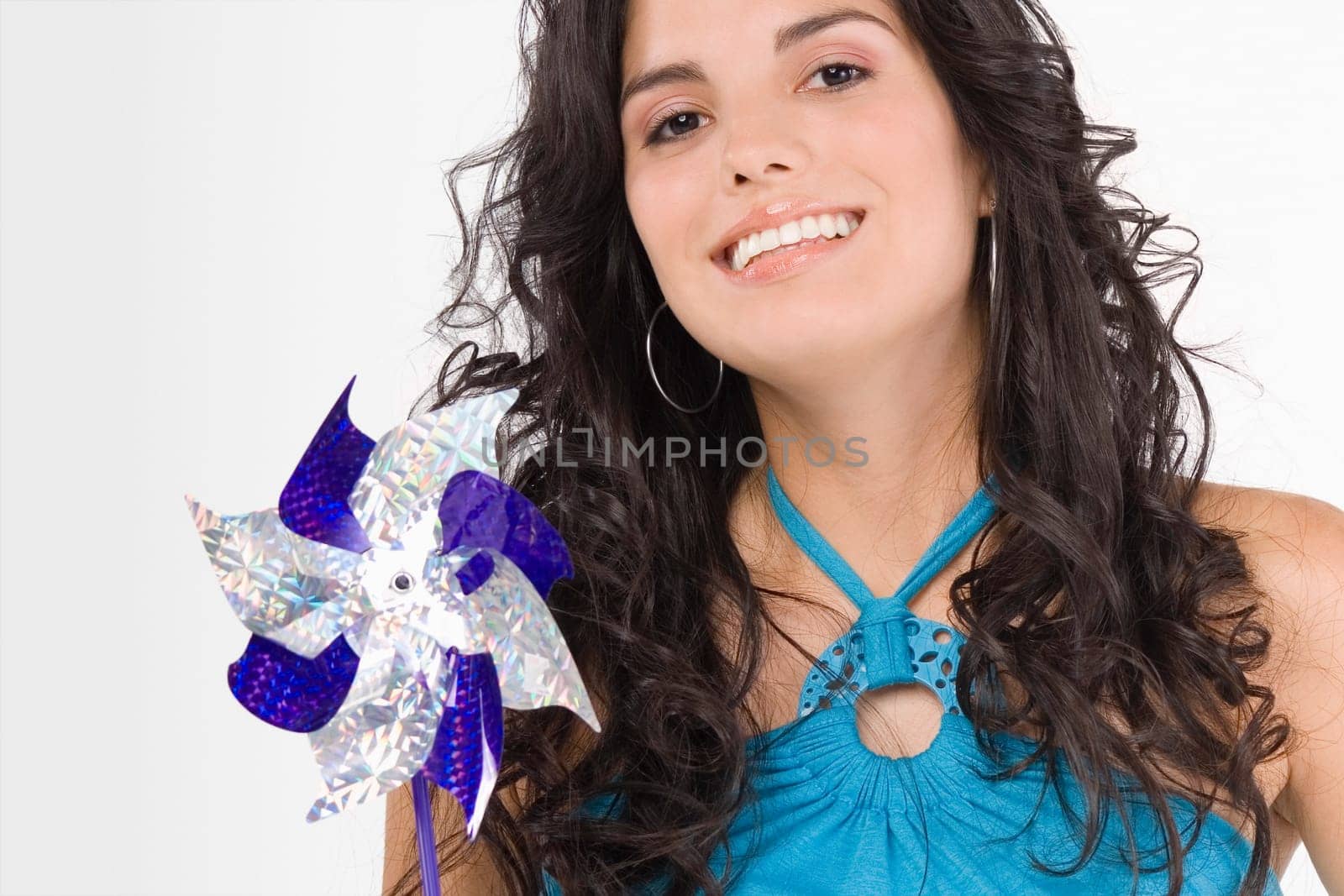 Portrait of a teenage girl holding a pinwheel and smiling