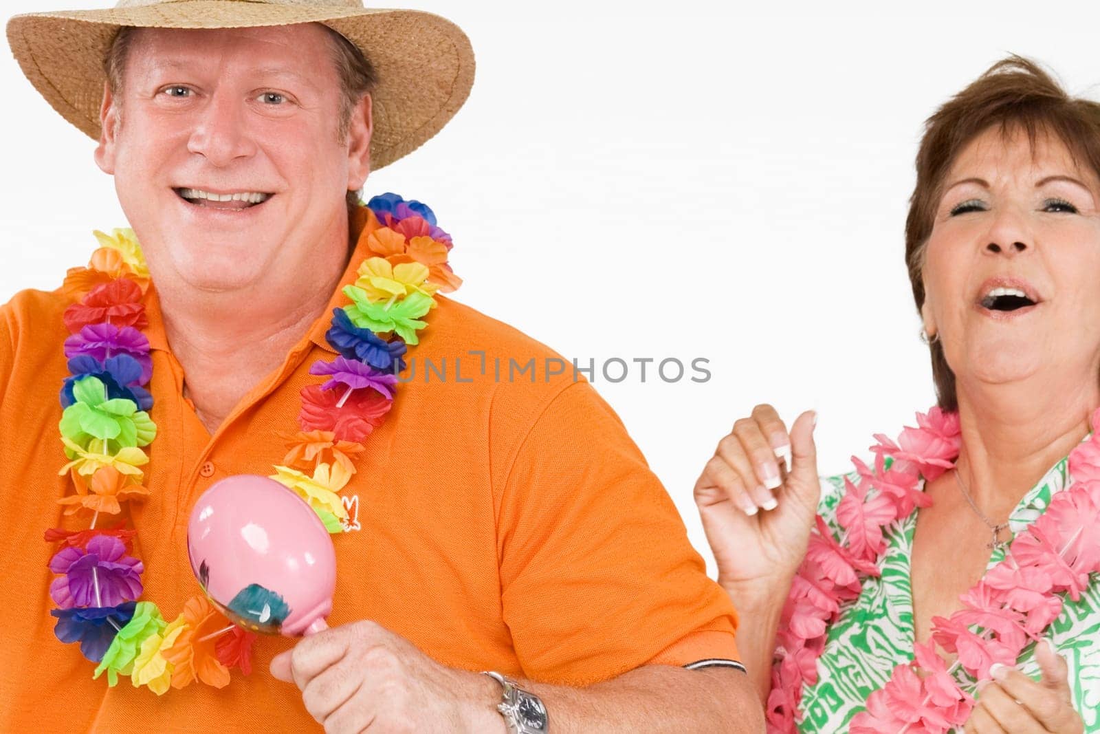 Portrait of a mature man holding maracas and a senior woman beside him