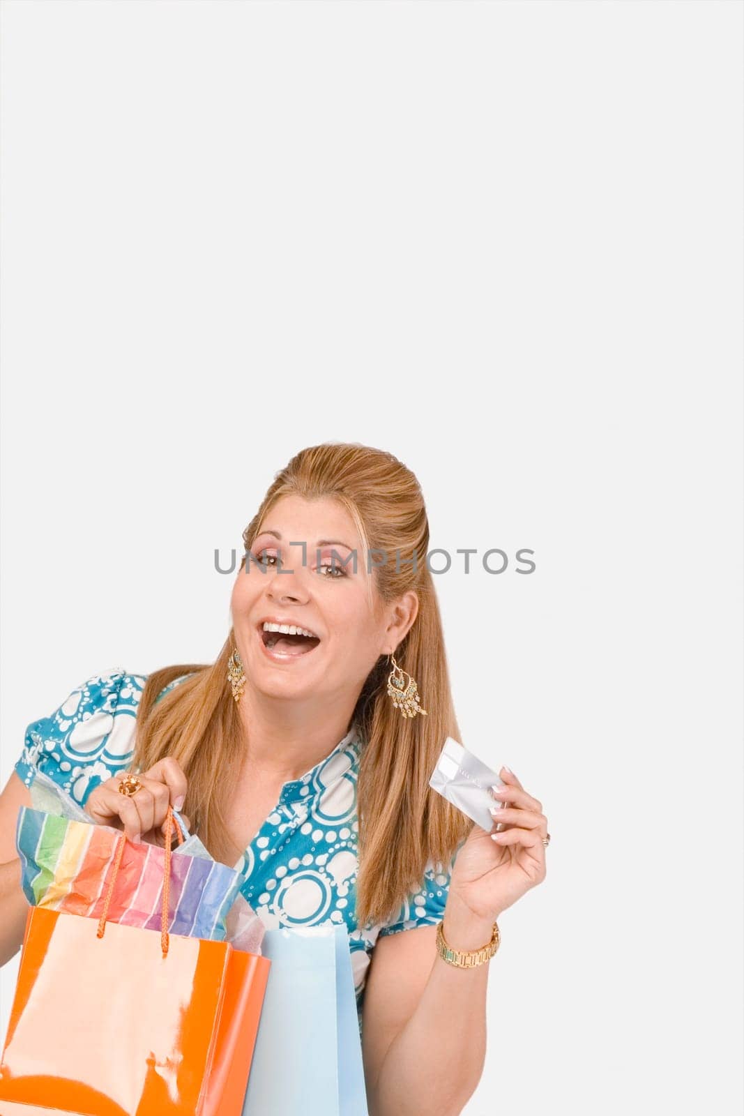 Portrait of a mature woman holding a credit card and shopping bags