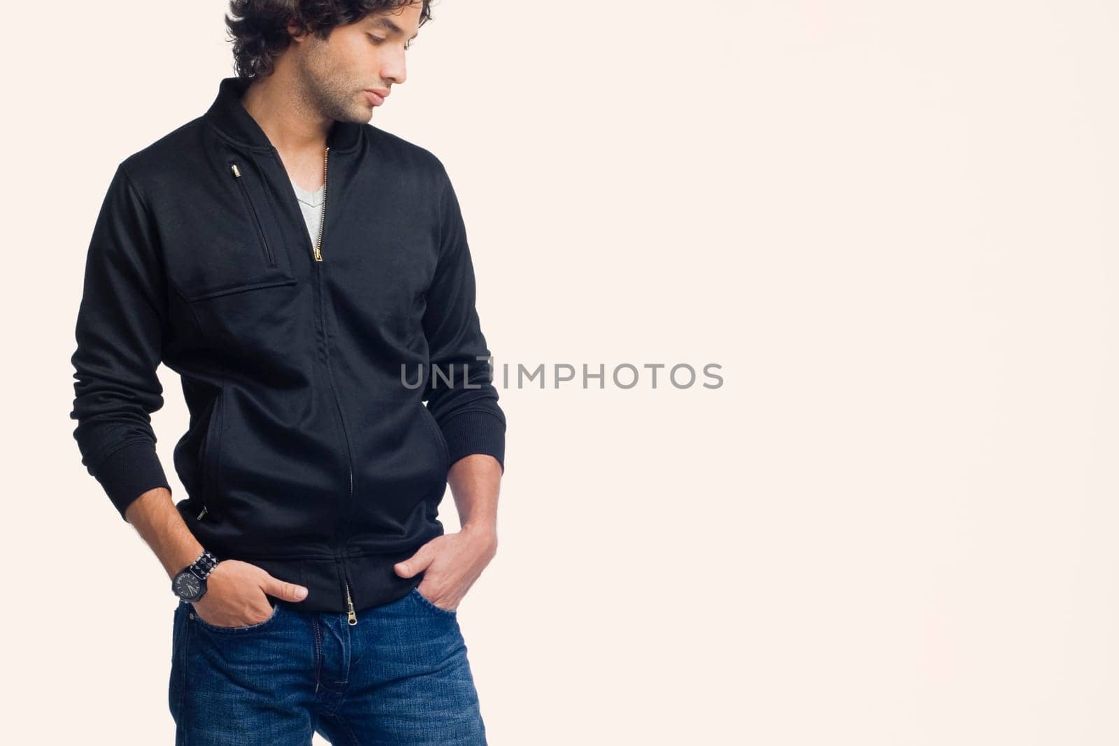 Young man standing with his hands in his pockets