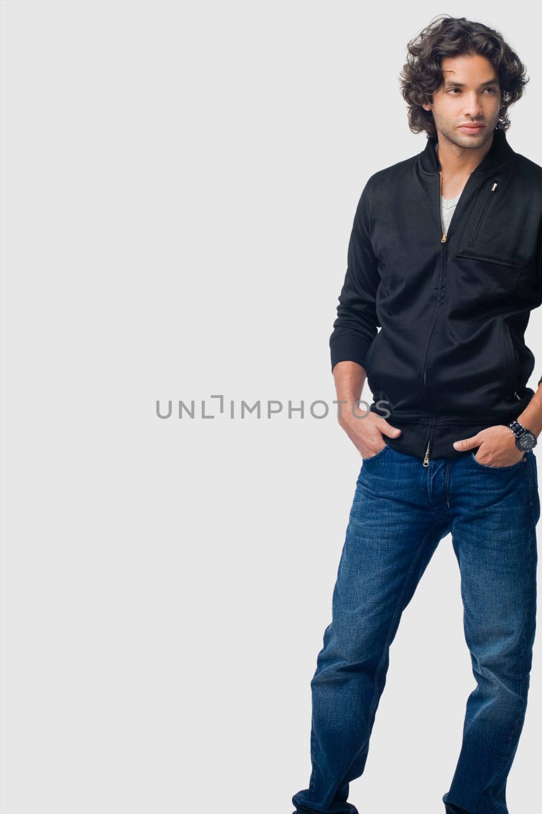 Young man standing with his hands in his pockets