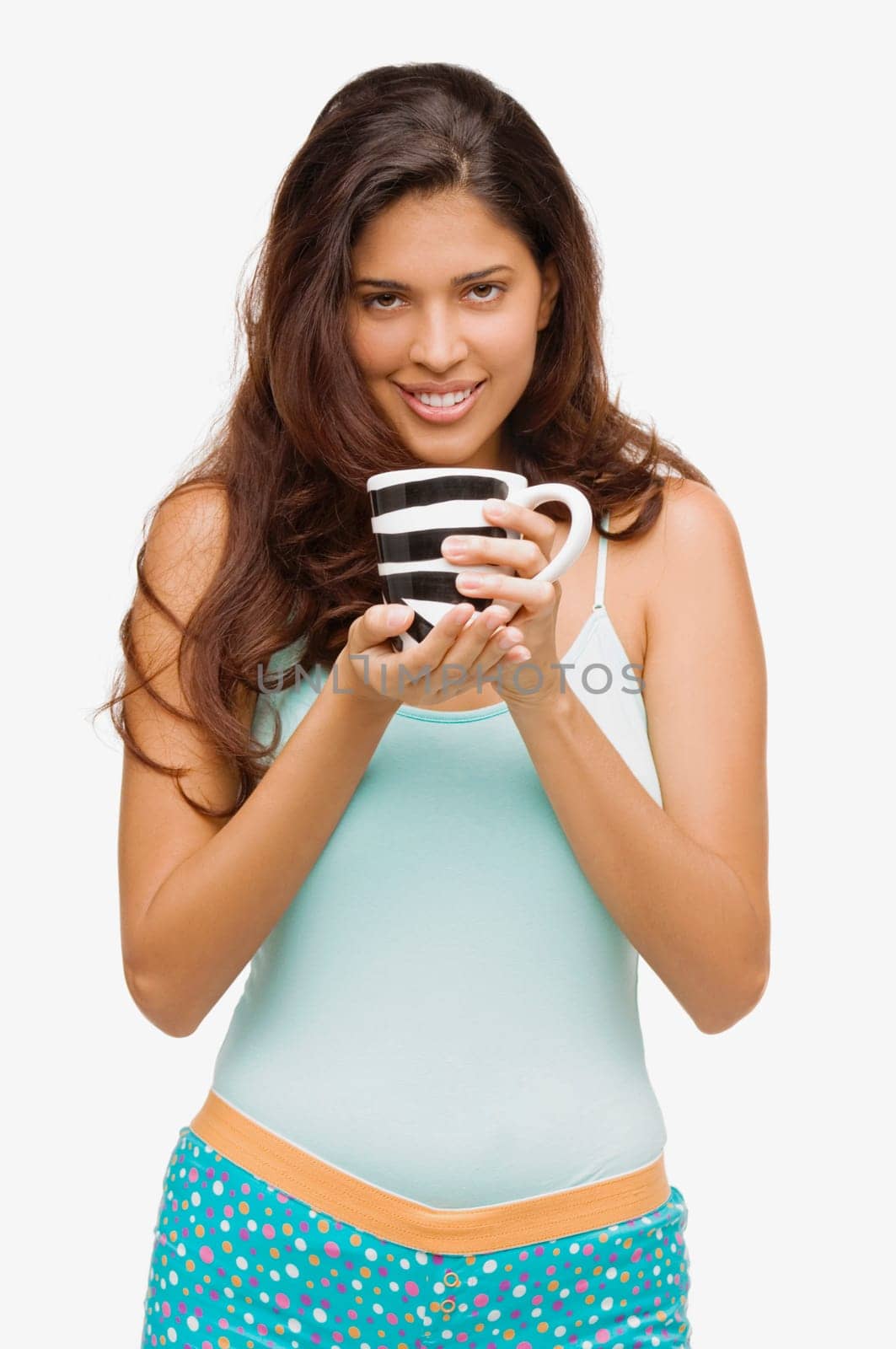 Portrait of a young woman holding a mug of coffee and smiling