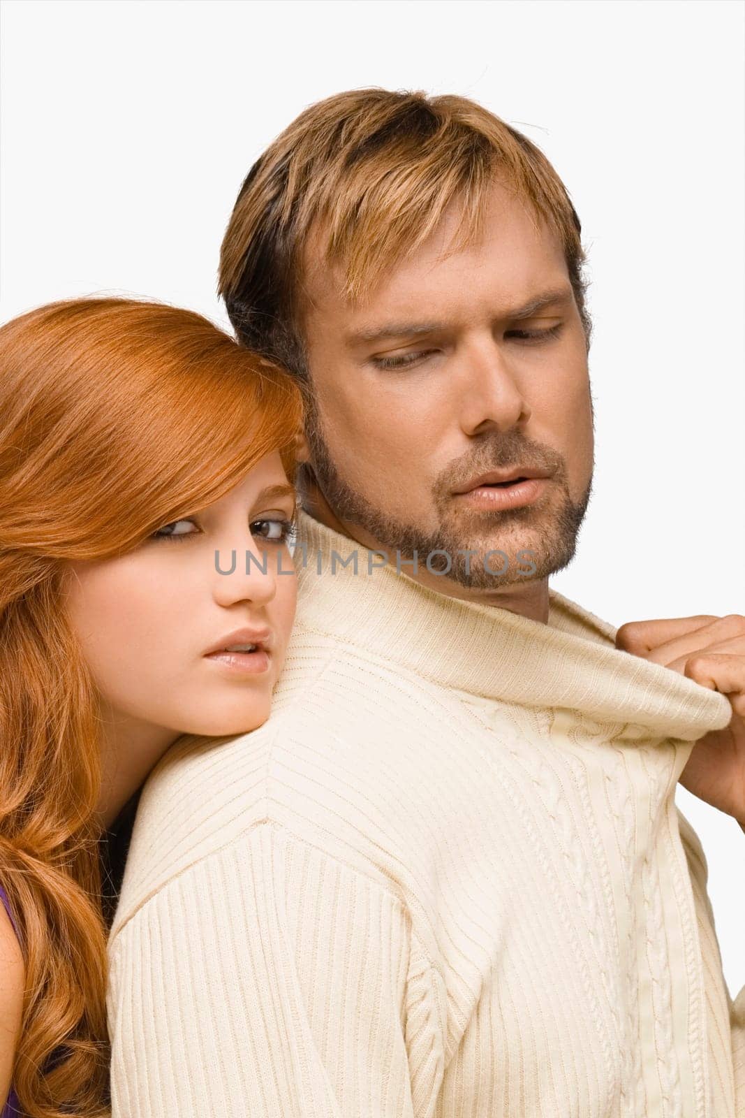 Portrait of a young woman resting her face on the shoulder of a mid adult man