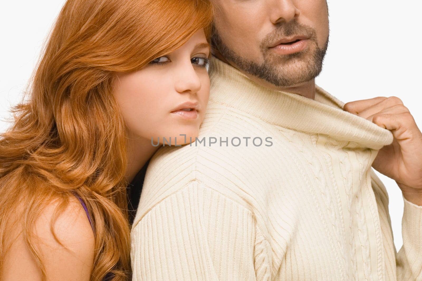 Portrait of a young woman resting her face on the shoulder of a mid adult man