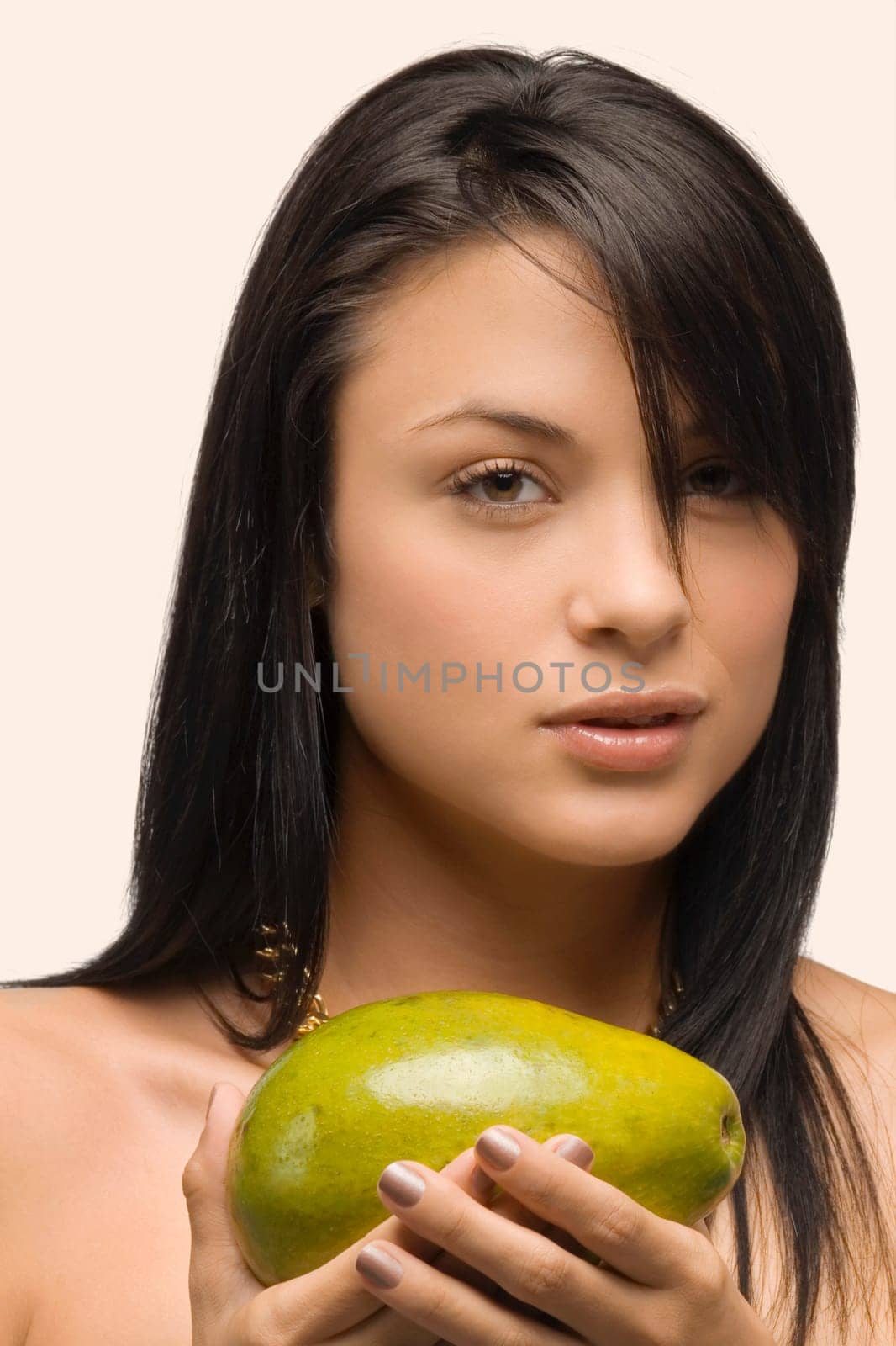 Portrait of a young woman holding an avocado