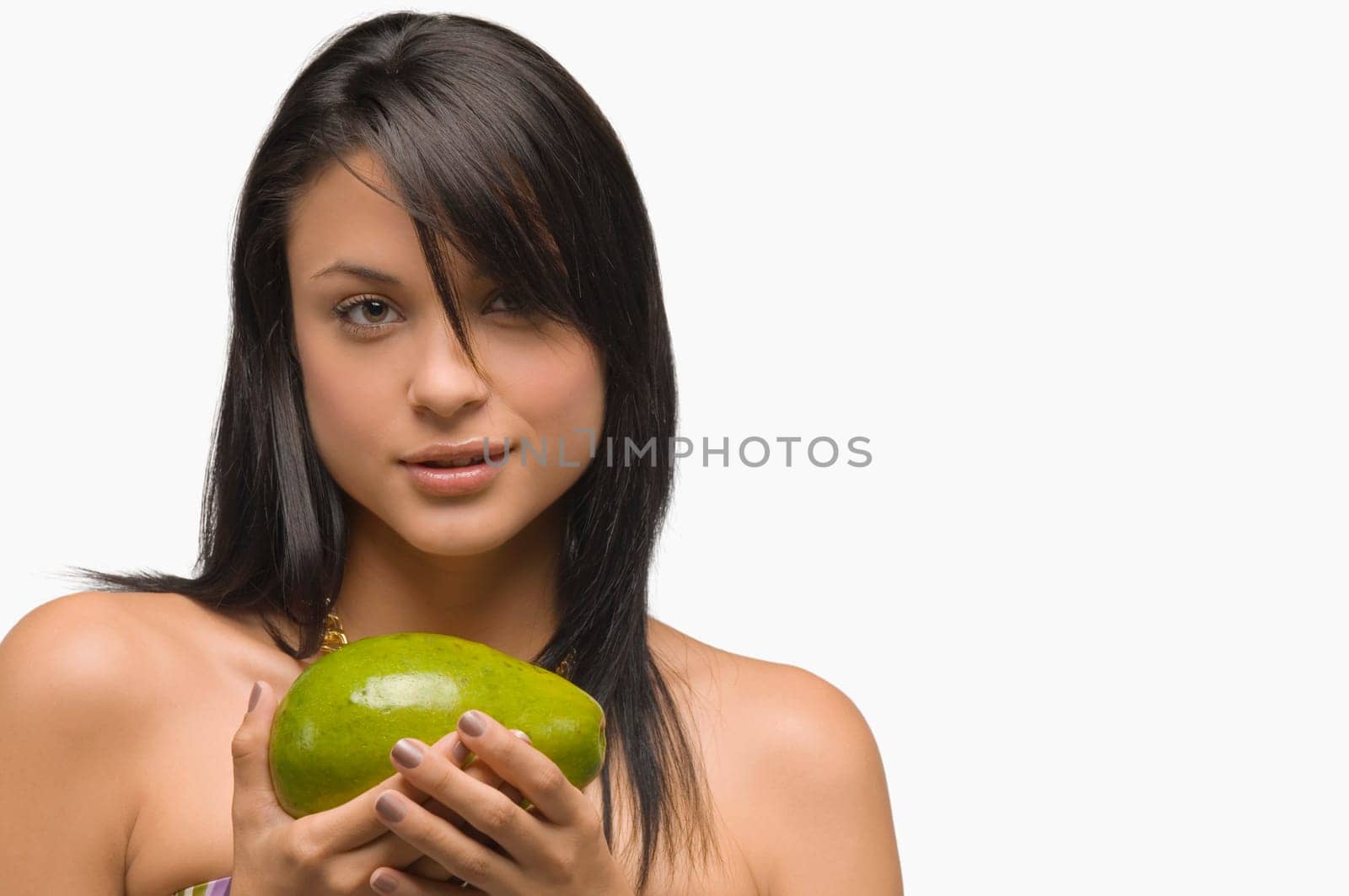 Portrait of a young woman holding an avocado