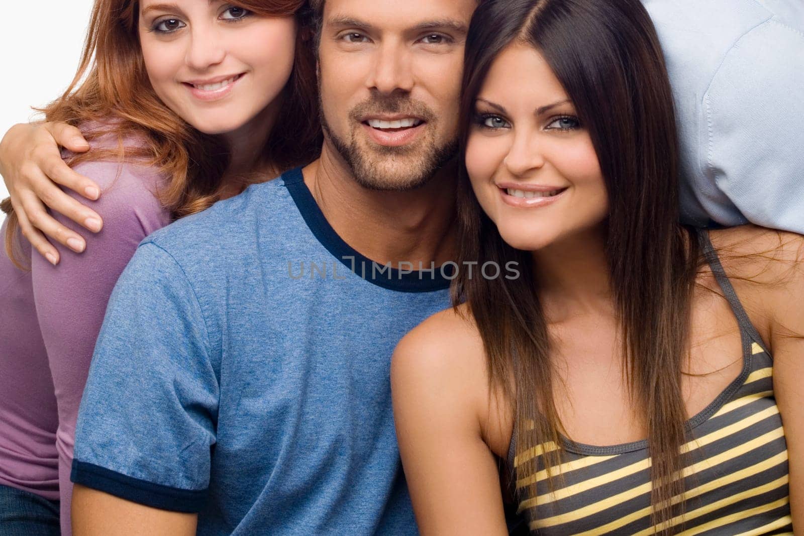Portrait of a mid adult man smiling with two young women