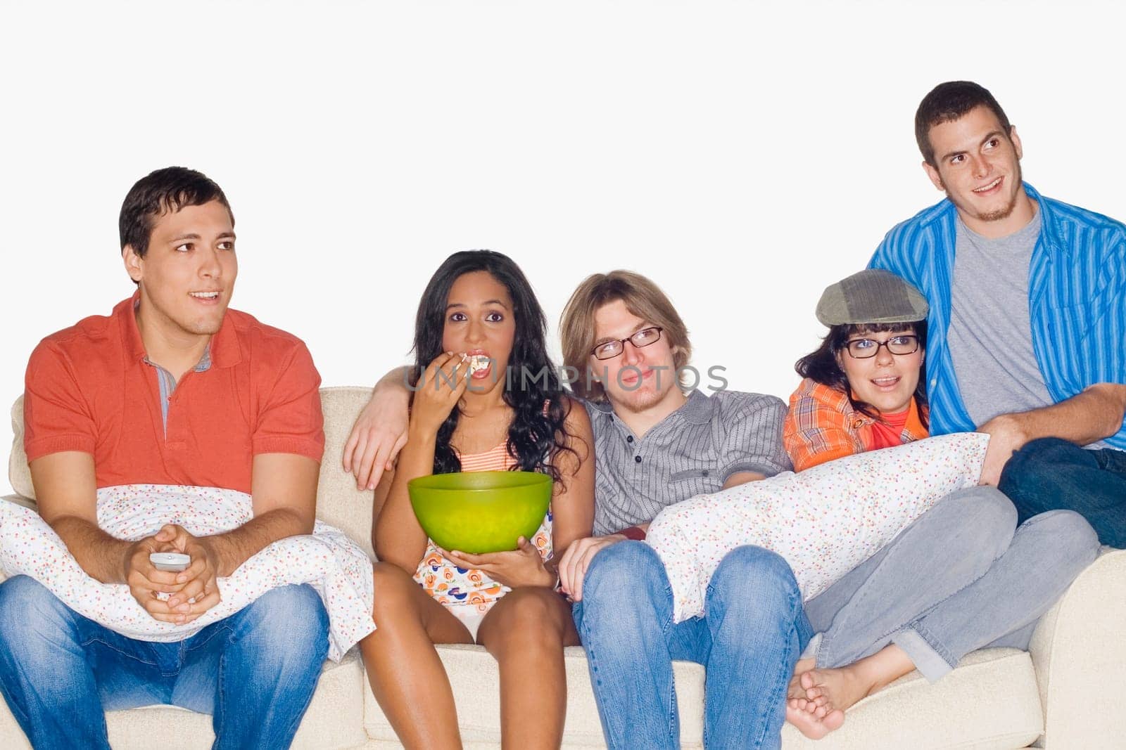 Five friends sitting on a couch and watching television