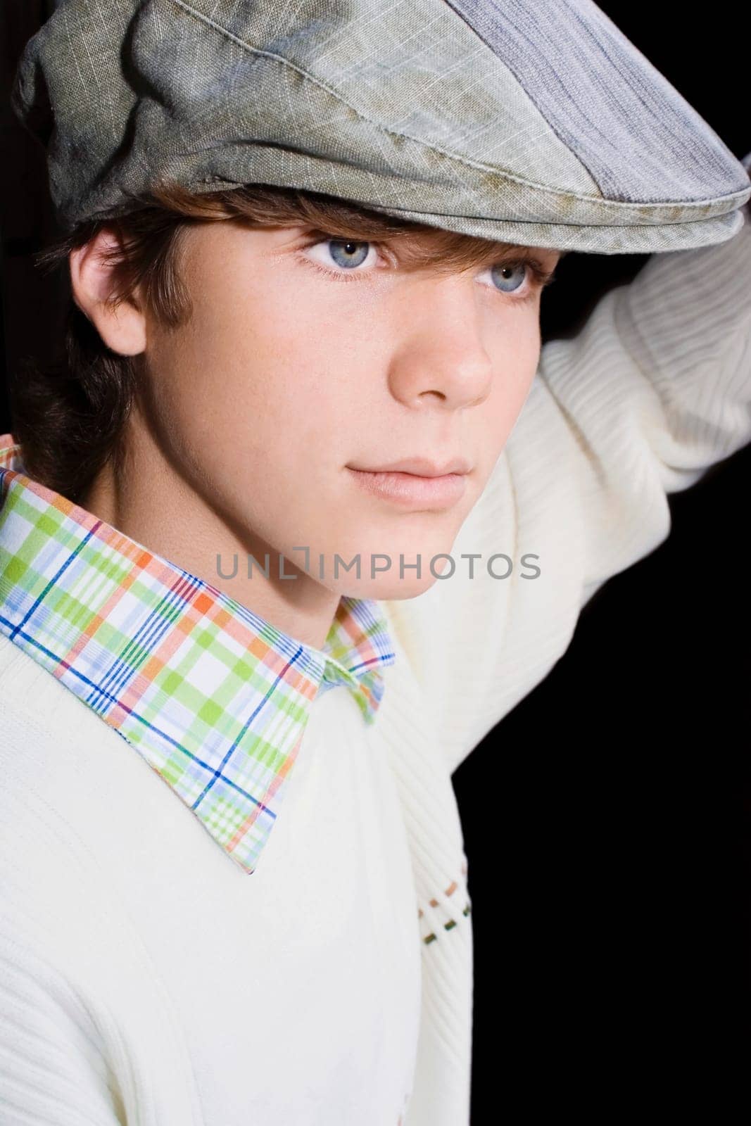 Close-up of a teenage boy wearing a flat cap