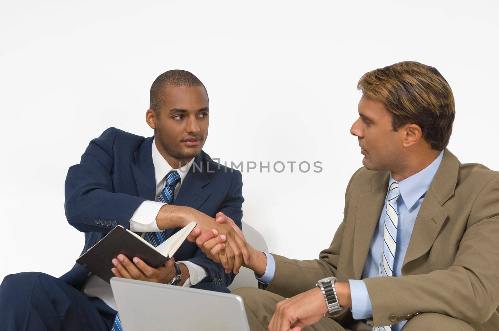 Two businessmen shaking hands with each other