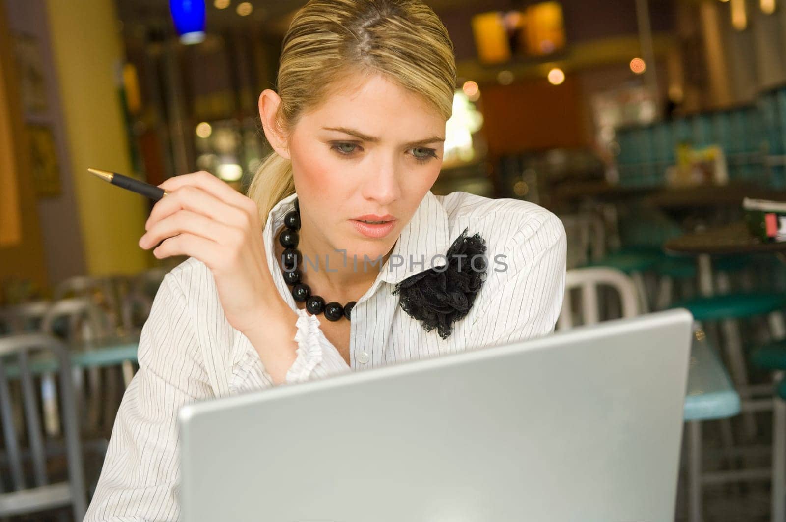 Businesswoman using a laptop in a restaurant