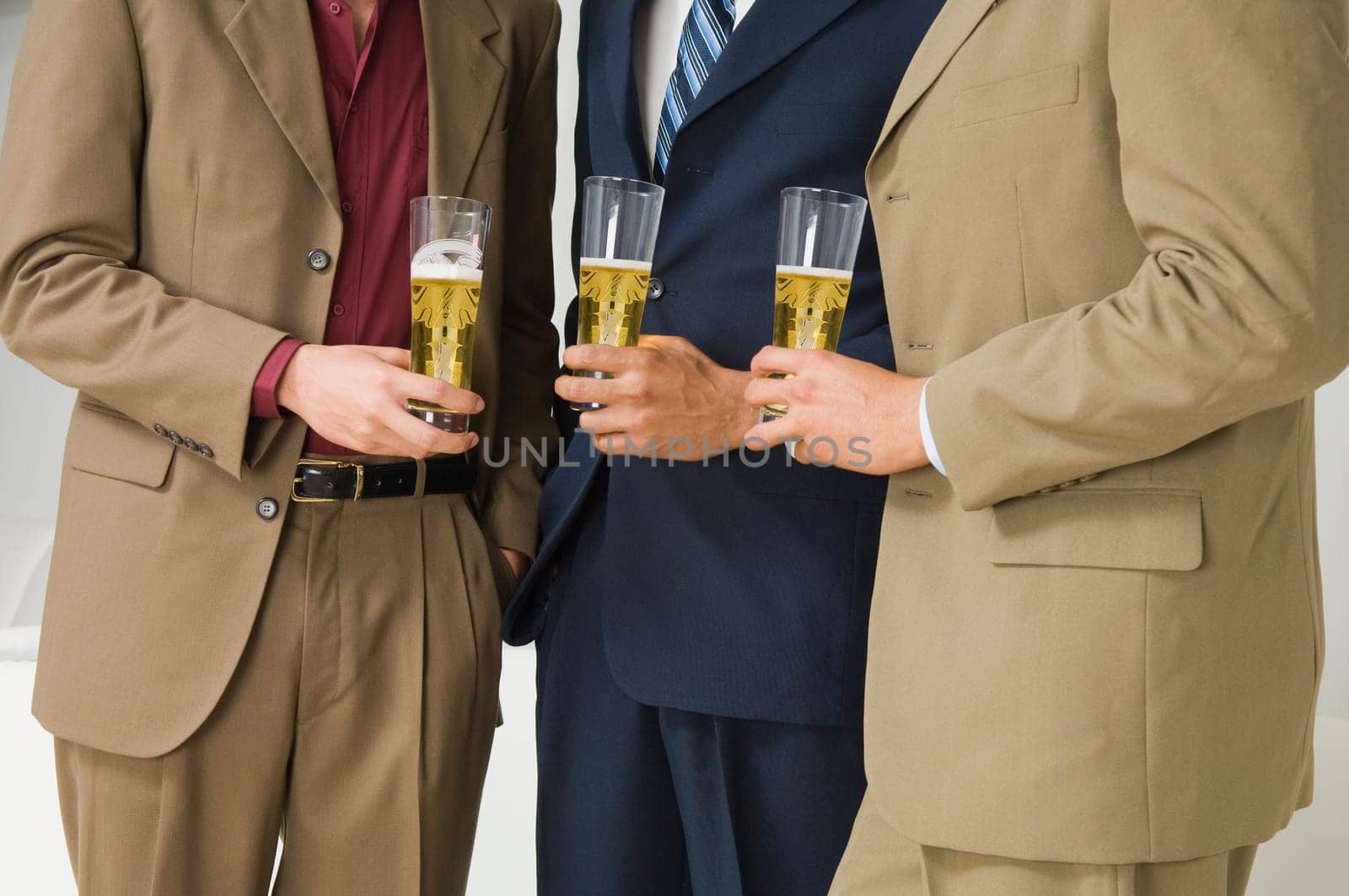 Three businessmen holding glasses of beer