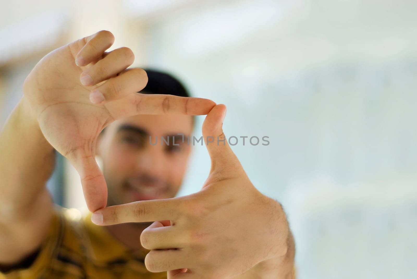 Young man making a finger frame
