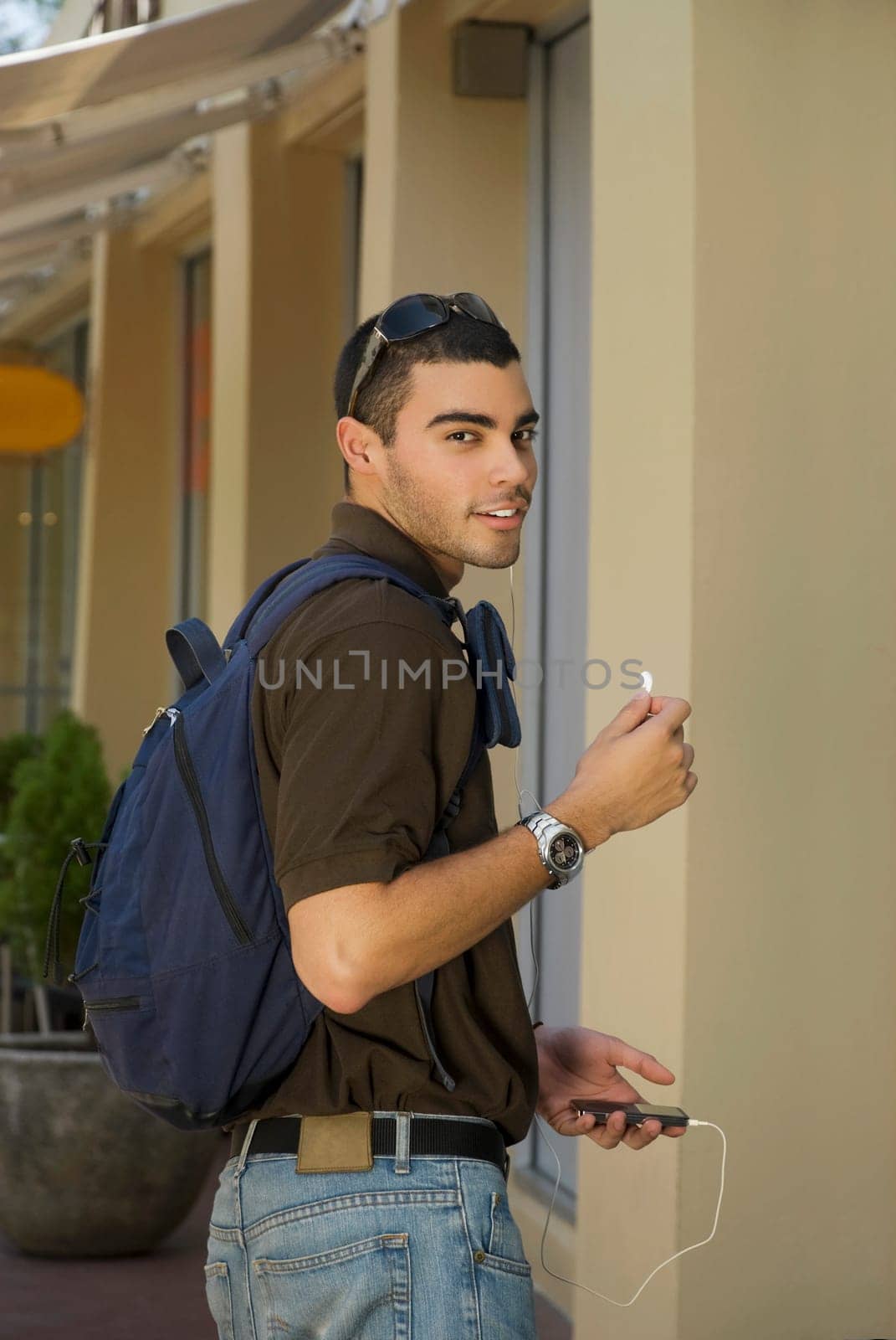 Portrait of a young man listening to an MP3 player
