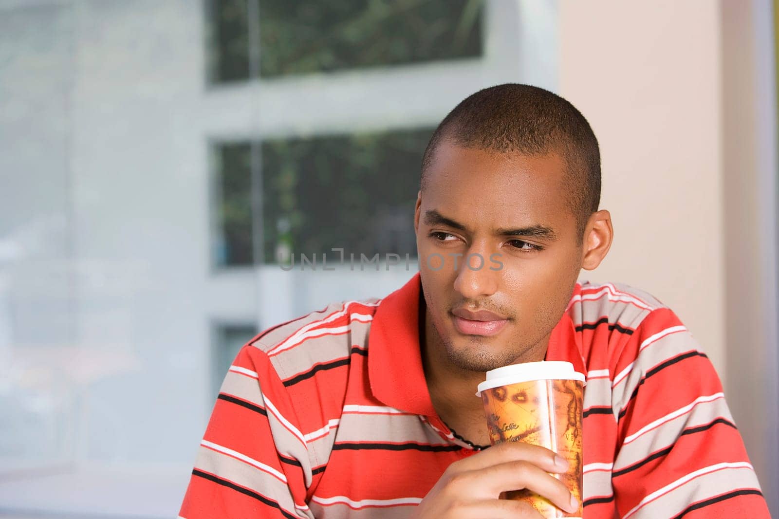 Close-up of a young man drinking coffee