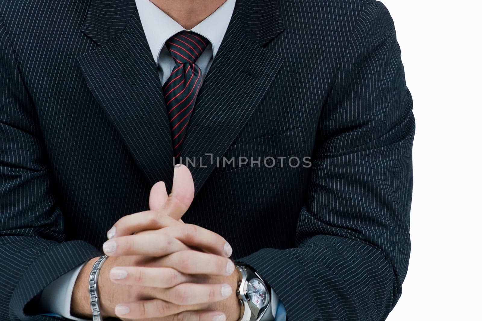 Mid section view of a businessman with his hands clasped