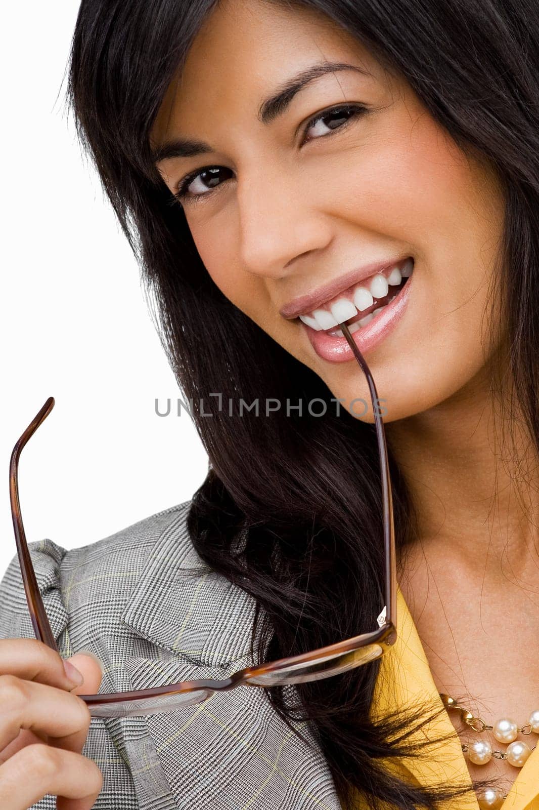 Portrait of a young woman holding a pair of eyeglasses and smiling