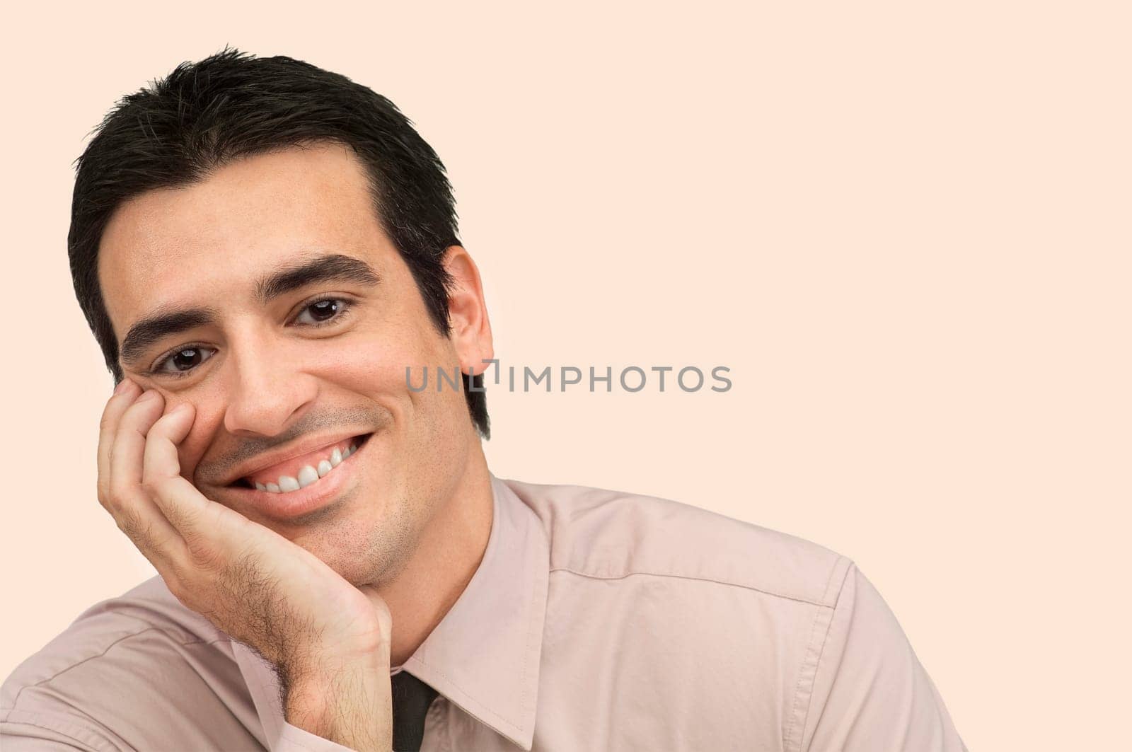 Portrait of a businessman smiling with his hand on his chin