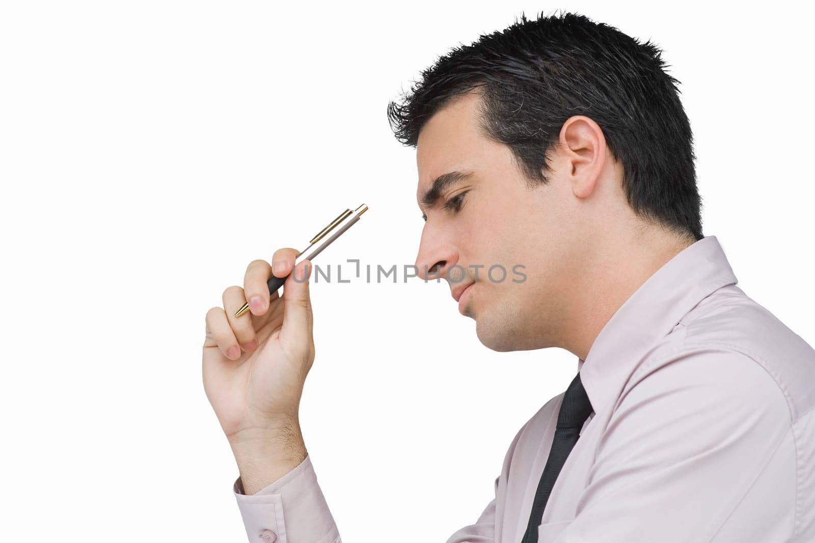 Close-up of a businessman holding a pen and thinking
