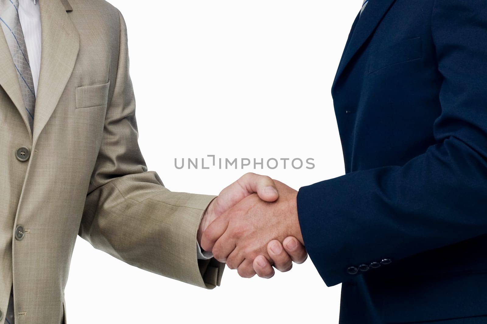 Mid section view of two businessmen shaking hands