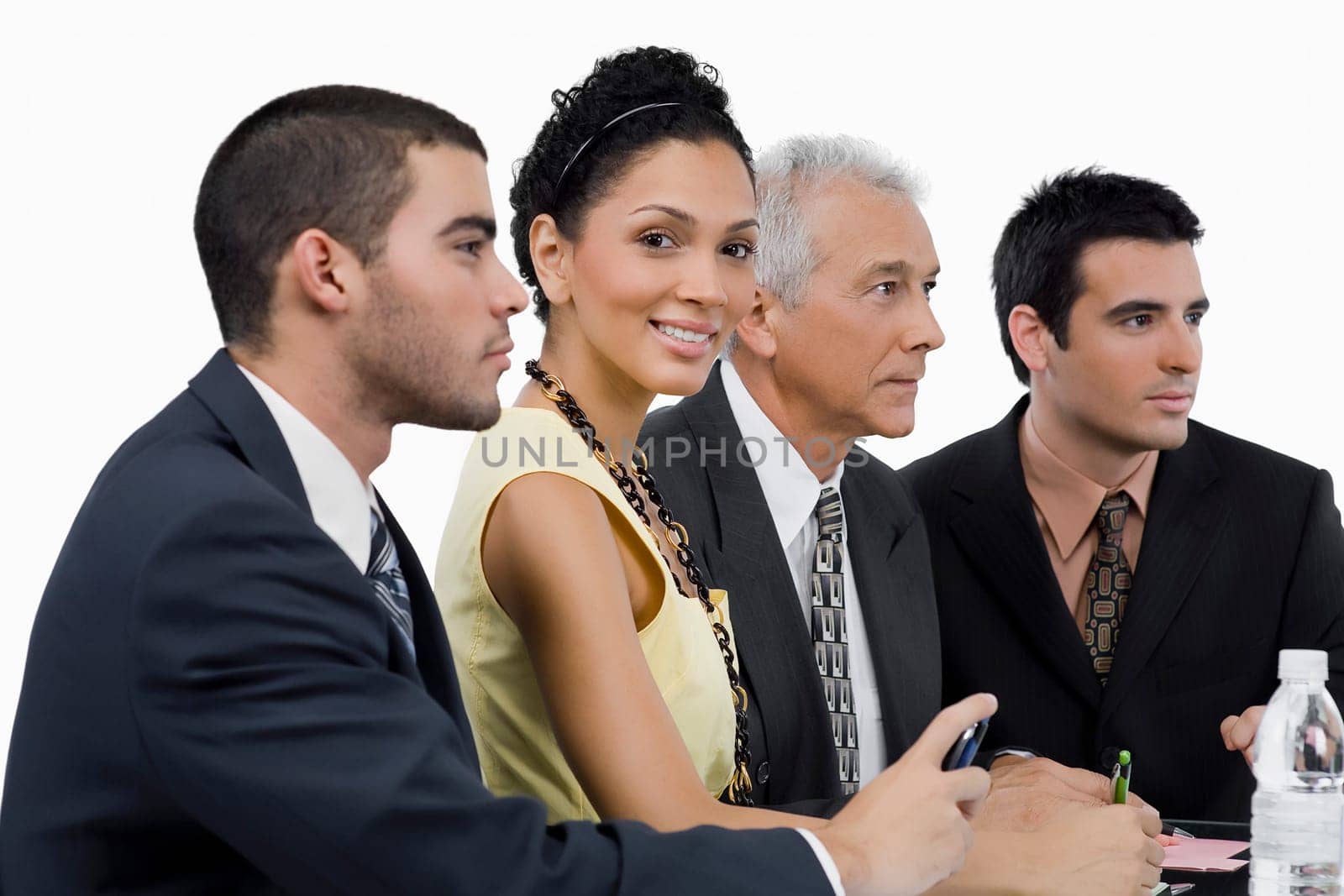 Three businessmen and a businesswoman at a meeting in a conference room